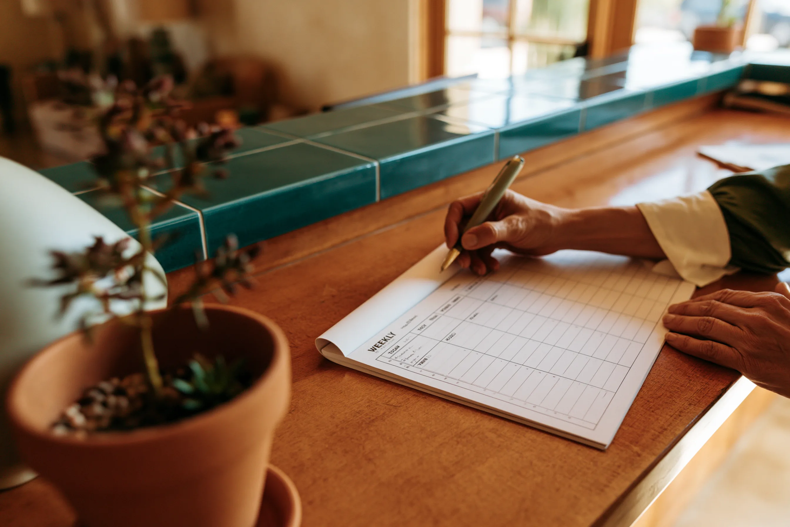 Front-office workflow scene: paperwork, monitor, and workspace surface, no faces or clinical instruments.